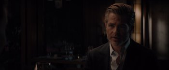 Movie still from “All the Old Knives” (2022), directed by Janus Metz – A person wearing a suit and tie; Close Up shot, Over the shoulder angle