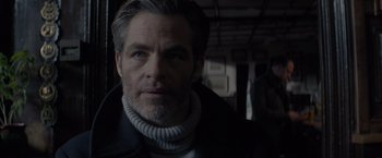 Movie still from “All the Old Knives” (2022), directed by Janus Metz – A person wearing a jacket; Close Up shot, Over the shoulder angle