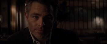 Movie still from “All the Old Knives” (2022), directed by Janus Metz – A person wearing a suit and tie; Close Up shot, Over the shoulder angle