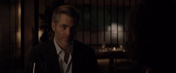 Movie still from “All the Old Knives” (2022), directed by Janus Metz – A person wearing a suit and tie; Close Up shot, Over the shoulder angle