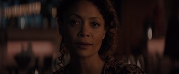 Movie still from “All the Old Knives” (2022), directed by Janus Metz – A person with curly brown hair; Close Up shot, Over the shoulder angle