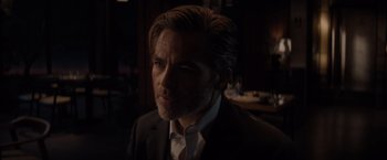 Movie still from “All the Old Knives” (2022), directed by Janus Metz – A person wearing a suit and tie; Close Up shot, Over the shoulder angle