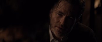 Movie still from “All the Old Knives” (2022), directed by Janus Metz – A person wearing a suit and tie; Close Up shot, Low angle