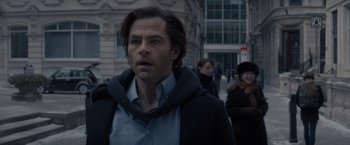 Movie still from “All the Old Knives” (2022), directed by Janus Metz – A person walking on the street; Close Up shot, Over the shoulder angle