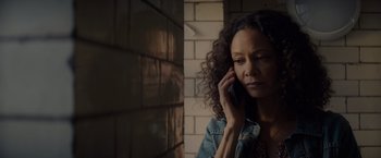 Movie still from “All the Old Knives” (2022), directed by Janus Metz – A woman is talking on a cell phone; Close Up shot, Low angle