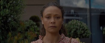 Movie still from “All the Old Knives” (2022), directed by Janus Metz – A person wearing a floral shirt; Close Up shot, Low angle