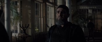 Movie still from “All the Old Knives” (2022), directed by Janus Metz – A man with a beard is looking at the camera; Close Up shot, Low angle