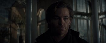 Movie still from “All the Old Knives” (2022), directed by Janus Metz – A person wearing a black jacket; Close Up shot, Over the shoulder angle