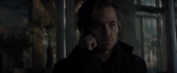 Movie still from “All the Old Knives” (2022), directed by Janus Metz – A person talking on a cell phone; Close Up shot, Over the shoulder angle