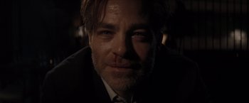 Movie still from “All the Old Knives” (2022), directed by Janus Metz – A person wearing a suit and tie; Close Up shot, Low angle