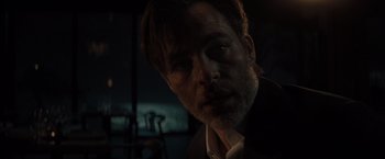 Movie still from “All the Old Knives” (2022), directed by Janus Metz – A person wearing a suit and beard; Close Up shot, Low angle