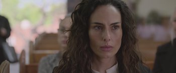 Movie still from “All the Places” (2023), directed by Pitipol Ybarra – A person with long curly hair; Close Up shot, Over the shoulder angle