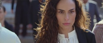 Movie still from “All the Places” (2023), directed by Pitipol Ybarra – A woman's face with long brown hair; Close Up shot, Over the shoulder angle