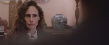 Movie still from “All the Places” (2023), directed by Pitipol Ybarra – A person sitting at a table; Close Up shot, Over the shoulder angle