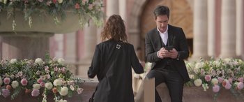 Movie still from “All the Places” (2023), directed by Pitipol Ybarra – A man and a woman are looking at a phone; Medium shot, Over the shoulder angle