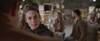 Movie still from “All the Places” (2023), directed by Pitipol Ybarra – A person sitting in a room; Close Up shot, Over the shoulder angle