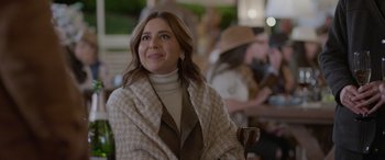 Movie still from “All the Places” (2023), directed by Pitipol Ybarra – A woman sitting in a chair with a scarf around her neck; Close Up shot, Over the shoulder angle