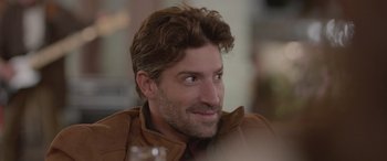 Movie still from “All the Places” (2023), directed by Pitipol Ybarra – A person wearing a jacket; Close Up shot, Over the shoulder angle