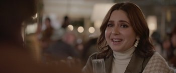 Movie still from “All the Places” (2023), directed by Pitipol Ybarra – A woman sitting at a table holding a glass of wine; Close Up shot, Over the shoulder angle