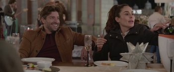 Movie still from “All the Places” (2023), directed by Pitipol Ybarra – A man and a woman sitting at a table with a glass of wine; Medium shot, Over the shoulder angle