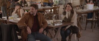 Movie still from “All the Places” (2023), directed by Pitipol Ybarra – A man and a woman sitting at a table; Medium shot, Over the shoulder angle