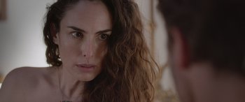 Movie still from “All the Places” (2023), directed by Pitipol Ybarra – A person with long brown hair; Close Up shot, Over the shoulder angle