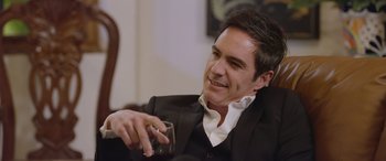 Movie still from “All the Places” (2023), directed by Pitipol Ybarra – A person holding a glass of wine; Close Up shot, Over the shoulder angle