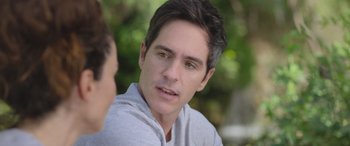 Movie still from “All the Places” (2023), directed by Pitipol Ybarra – A person talking to another person; Close Up shot, Over the shoulder angle