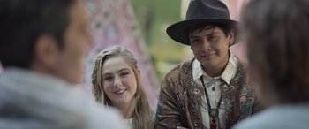 Movie still from “All the Places” (2023), directed by Pitipol Ybarra – A man and a woman pose for a picture; Close Up shot, Over the shoulder angle