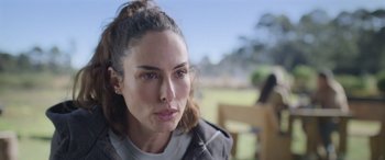 Movie still from “All the Places” (2023), directed by Pitipol Ybarra – A person wearing a jacket; Close Up shot, Over the shoulder angle