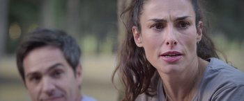 Movie still from “All the Places” (2023), directed by Pitipol Ybarra – A person with long curly hair; Close Up shot, Over the shoulder angle