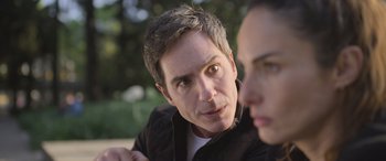 Movie still from “All the Places” (2023), directed by Pitipol Ybarra – A person sitting next to another person; Close Up shot, Over the shoulder angle