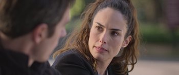 Movie still from “All the Places” (2023), directed by Pitipol Ybarra – A person talking to another person; Close Up shot, Over the shoulder angle