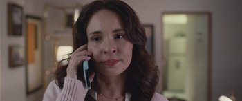 Movie still from “All the Places” (2023), directed by Pitipol Ybarra – A person talking on a cell phone; Close Up shot, Over the shoulder angle