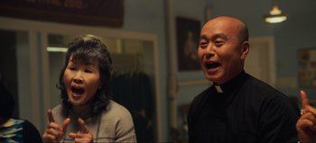 Movie still from “All Together Now” (2020), directed by Brett Haley – A man and a woman standing next to each other in a room; Close Up shot, Over the shoulder angle