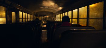 Movie still from “All Together Now” (2020), directed by Brett Haley – A person sitting on a bus looking out the window; Extreme Wide shot, High angle