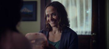 Movie still from “All Together Now” (2020), directed by Brett Haley – A woman smiles while holding a pink plate; Close Up shot, Over the shoulder angle