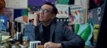 Movie still from “All Together Now” (2020), directed by Brett Haley – A man in a suit and glasses sitting at a table; Medium shot, Over the shoulder angle
