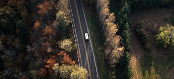 Movie still from “All Together Now” (2020), directed by Brett Haley – An aerial view of a car driving down the road; Extreme Wide shot, Overhead angle