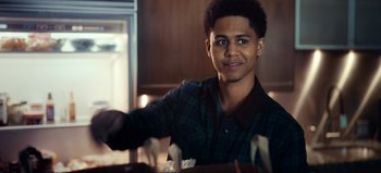 Movie still from “All Together Now” (2020), directed by Brett Haley – A young man is sitting at a dining table; Close Up shot, Over the shoulder angle