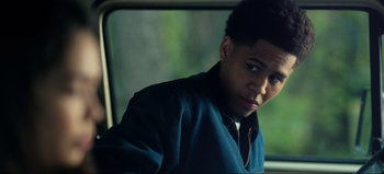 Movie still from “All Together Now” (2020), directed by Brett Haley – A man sitting in a car looking out the window; Close Up shot, Over the shoulder angle