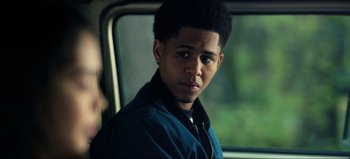 Movie still from “All Together Now” (2020), directed by Brett Haley – A young man sitting in a car looking out the window; Close Up shot, Over the shoulder angle