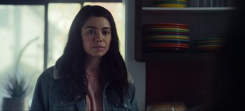 Movie still from “All Together Now” (2020), directed by Brett Haley – A woman with long black hair wearing a jean jacket; Close Up shot, Over the shoulder angle
