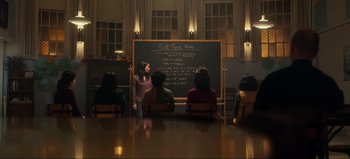 Movie still from “All Together Now” (2020), directed by Brett Haley – A group of people sitting in front of a chalkboard; Wide shot, High angle