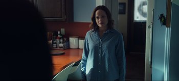 Movie still from “All Together Now” (2020), directed by Brett Haley – A woman standing in front of a kitchen counter; Medium shot, Over the shoulder angle