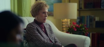 Movie still from “All Together Now” (2020), directed by Brett Haley – An older woman sitting on a chair in a living room; Medium shot, Over the shoulder angle