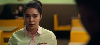Movie still from “All Together Now” (2020), directed by Brett Haley – A woman in a pink and white shirt looking at the camera; Close Up shot, Over the shoulder angle