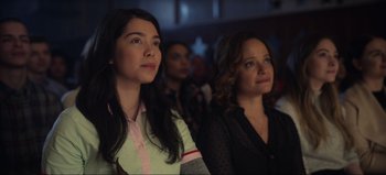 Movie still from “All Together Now” (2020), directed by Brett Haley – Two women sitting next to each other in front of a crowd; Close Up shot, Over the shoulder angle