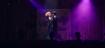 Movie still from “All Together Now” (2020), directed by Brett Haley – A man and a woman dancing on a stage in front of purple lights; Wide shot, Low angle