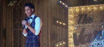 Movie still from “All Together Now” (2020), directed by Brett Haley – A young man wearing a vest and bow tie; Medium shot, Over the shoulder angle